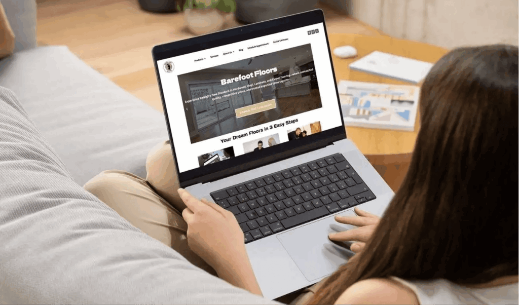 woman on laptop looking at barefoot flooring